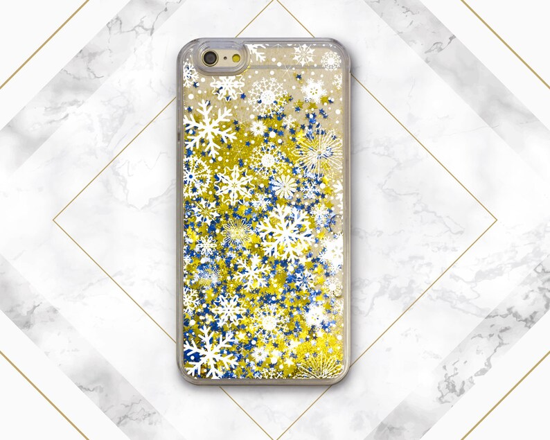 May include: A clear phone case with a glittery design featuring white snowflakes and blue and gold stars.