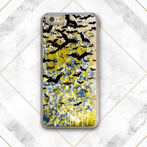 May include: A black iPhone case with a glittery design featuring bats, spiderwebs, and stars in shades of yellow and blue.