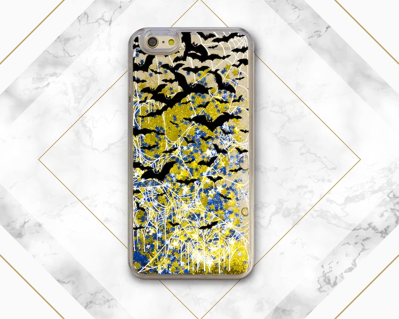 May include: A black iPhone case with a glittery design featuring bats, spiderwebs, and stars in shades of yellow and blue.