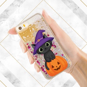 May include: A gold glitter phone case with a black cat wearing a purple witch hat and sitting on a jack-o'-lantern.