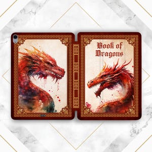 May include: A red leather-bound book with a gold border and the title "Book of Dragons" on the front cover. The cover features two watercolor illustrations of red dragons with detailed scales and wings.