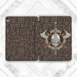 May include: A brown tablet case featuring a Viking theme. The case has a repeating pattern of symbols on the front and back. The back features a Viking helmet, crossed axes, and a sword within a circular design.