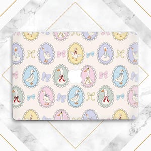 May include: A laptop skin featuring a repeating pattern of cartoon geese in oval frames. The frames are pastel colors, with bows and ribbons. The background is a light beige.