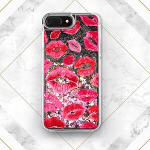 May include: Clear phone case with a glittery black background and red lips print.