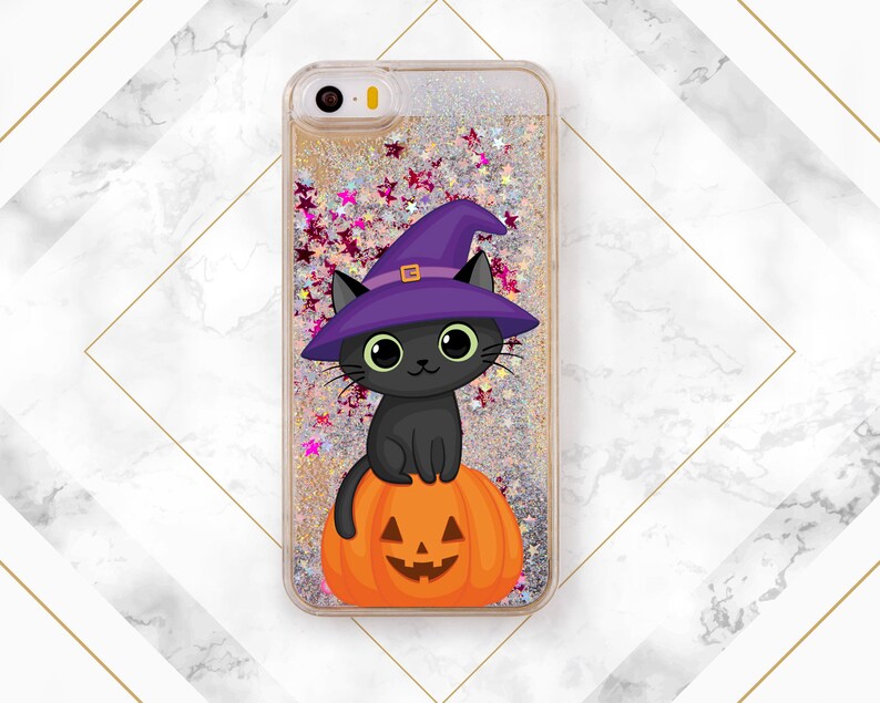 May include: A clear phone case with a glittery background and a black cat wearing a purple witch hat sitting on a jack-o-lantern.