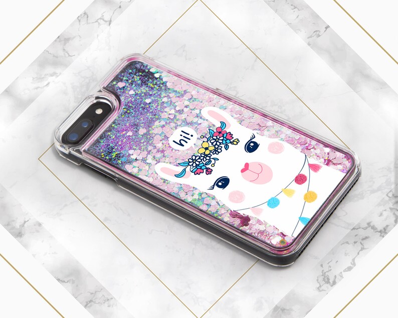 May include: A clear phone case with a pink, purple, and white glitter background. A white llama with a pink nose and a flower crown is featured on the case. The llama has a speech bubble that says "hi!"