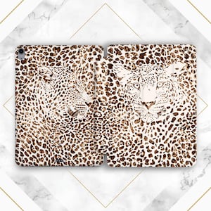May include: A white and brown leopard print phone case with two leopard silhouettes. The case is designed to fit a tablet or phone.
