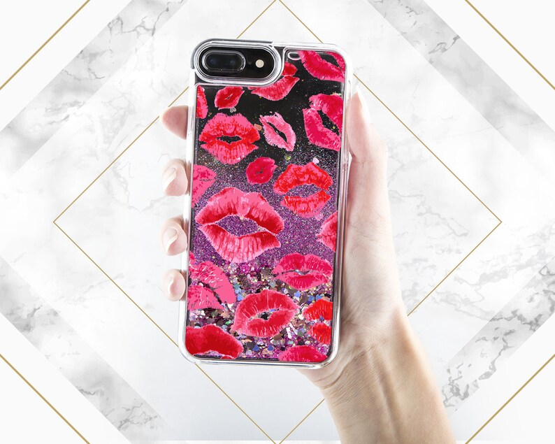 May include: A clear phone case with a glittery pink and purple background and a pattern of red lips.