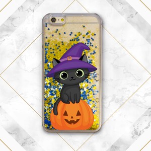 May include: A black cat wearing a purple witch hat sits on top of an orange pumpkin with a jack-o'-lantern face. The image is set against a background of gold and blue glitter.