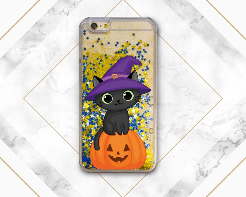 May include: A black cat wearing a purple witch hat sits on top of an orange pumpkin with a jack-o'-lantern face. The image is set against a background of gold and blue glitter.