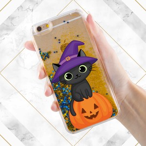 May include: A clear phone case with a black cat wearing a purple witch hat and sitting on a jack-o-lantern. The case is filled with gold glitter and blue stars.