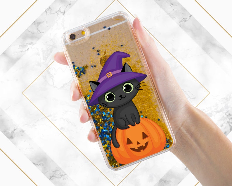 May include: A clear phone case with a black cat wearing a purple witch hat and sitting on a jack-o-lantern. The case is filled with gold glitter and blue stars.