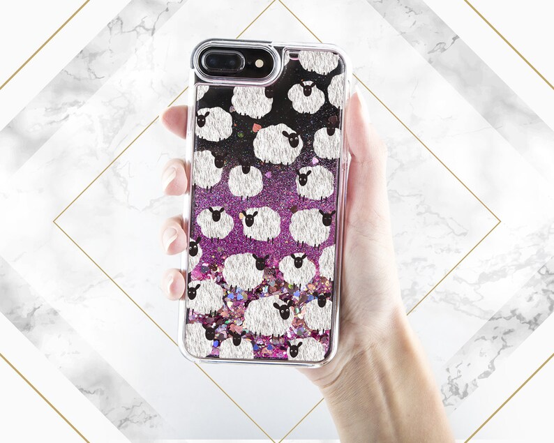 May include: A clear phone case with a pink and black glitter background and a white sheep pattern.