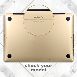 May include: Gold-coloured MacBook Pro laptop with the text "MacBook Pro" and FCC and CE markings on the back.