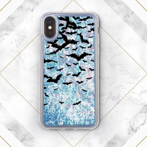 May include: A clear phone case with a blue and white glitter background and a black silhouette of bats flying over a spiderweb design.