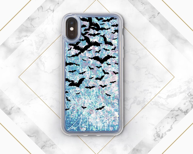 May include: A clear phone case with a blue and white glitter background and a black silhouette of bats flying over a spiderweb design.