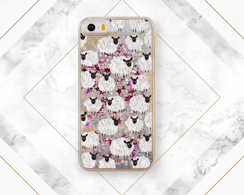 May include: A clear phone case with a glittery background and a repeating pattern of white sheep with black faces.