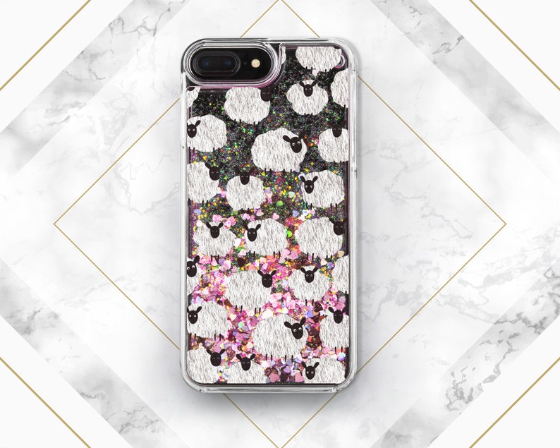 May include: A clear phone case with a glittery pink and black background. The case features a repeating pattern of white sheep with black faces.