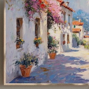 May include: Oil painting depicting a sunlit European street scene. White buildings with terracotta roofs and window boxes filled with flowers. Bougainvillea cascades from the rooftops. The cobblestone street is painted with long shadows.