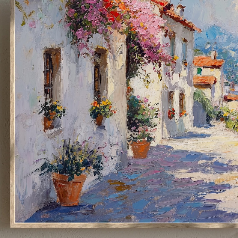 May include: Oil painting depicting a sunlit European street scene. White buildings with terracotta roofs and window boxes filled with flowers. Bougainvillea cascades from the rooftops. The cobblestone street is painted with long shadows.