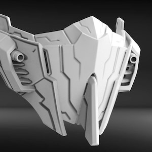 May include: A white, futuristic-looking mask with a sharp, angular design. The mask has a series of intricate details and a pointed chin.