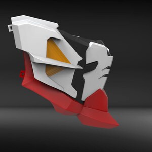 May include: A white, red and black plastic model with a yellow and white geometric design. The model has a sharp, angular shape.