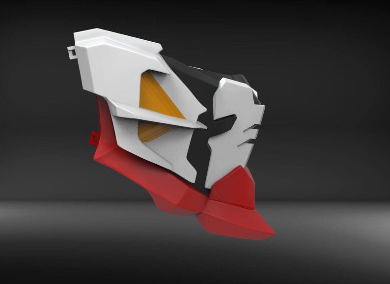 May include: A white, red and black plastic model with a yellow and white geometric design. The model has a sharp, angular shape.