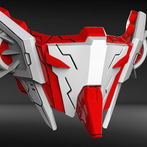 May include: A red and white futuristic mask with sharp angles and a geometric design. The mask has a large, central panel with a white background and black lines. The mask is made of a hard, plastic-like material.