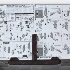May include: A black and white instruction manual for building a model kit. The manual is open to a page with diagrams and instructions for assembling the model. The manual is on a black stand with red accents.
