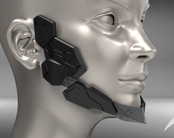 Pode incluir: Uma máscara facial preta e cinza com um design geométrico. A máscara cobre a metade inferior do rosto, incluindo o queixo e a linha do maxilar.
