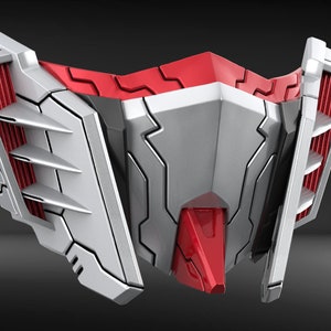 May include: A futuristic-looking mask with a red and white color scheme. The mask has a sharp, angular design with intricate details.