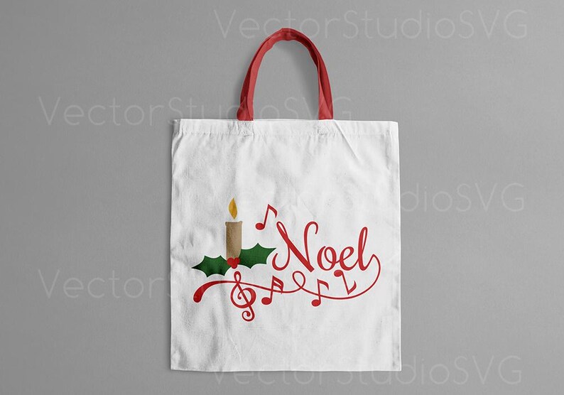 May include: A white tote bag with red handles features a Christmas-themed design. The design includes a candle, holly, and musical notes with the word "Noel" in red cursive.