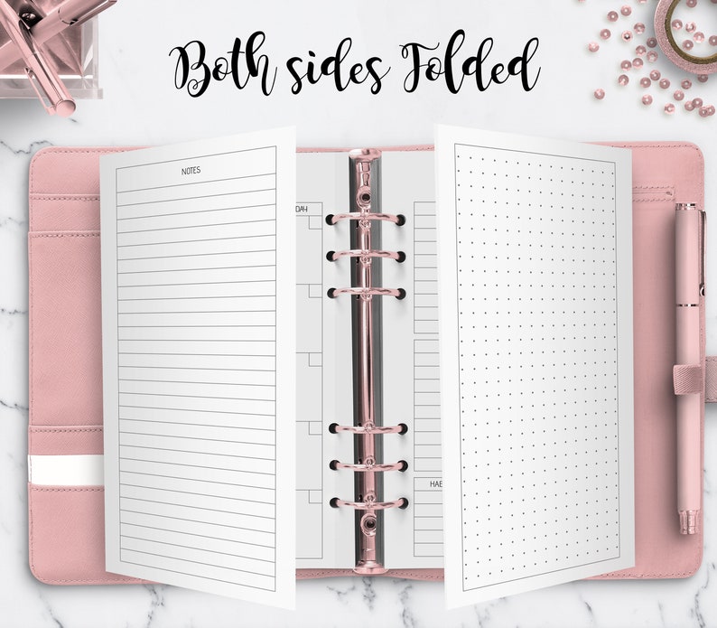 May include: A pink leather bound planner with a rose gold ring binder. The planner is open to a page with lined paper on the left and a page with a dotted grid on the right. The text "Both sides folded" is written in black cursive at the top of the image.