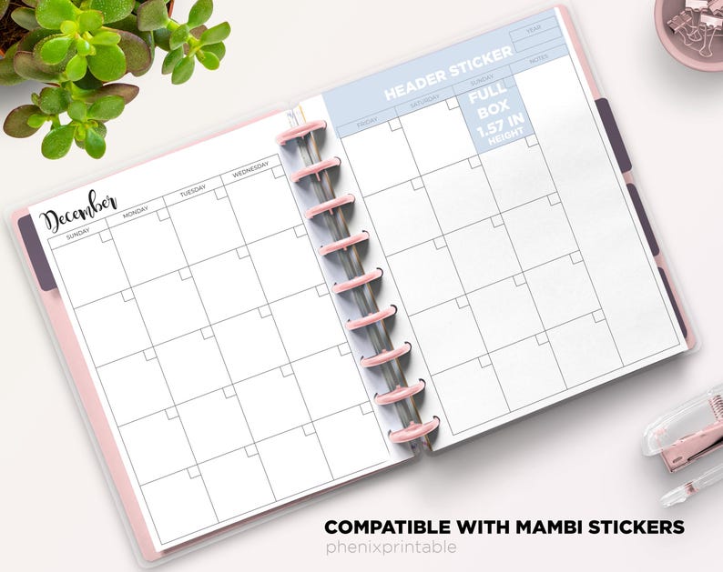 May include: A disc-bound planner open to a December monthly calendar layout with white pages, black grid lines, and pink binding discs. The page includes text labels for days of the week, a header sticker section, and a full box measuring 1.57 inches in height.