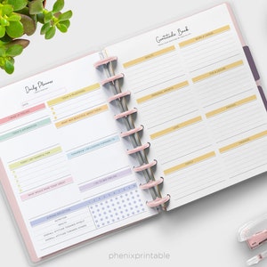 May include: A printable daily planner and gratitude journal with pink, yellow, and blue accents. The planner includes sections for daily reflections, gratitude, and milestones. The journal has sections for health, home and career, fun and leisure, love, family, friends, and finances.