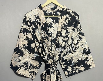 May include: Black floral print kimono robe with a long tie belt. The robe has a V-neck and 3/4 sleeves.