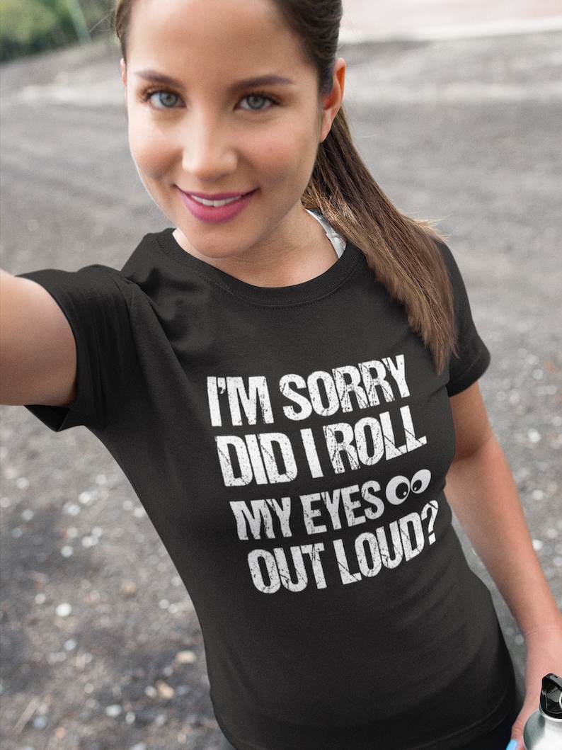 May include: Black t-shirt with the text "I'M SORRY DID I ROLL MY EYES OUT LOUD?" in white, distressed font. The shirt is a crew neck style.