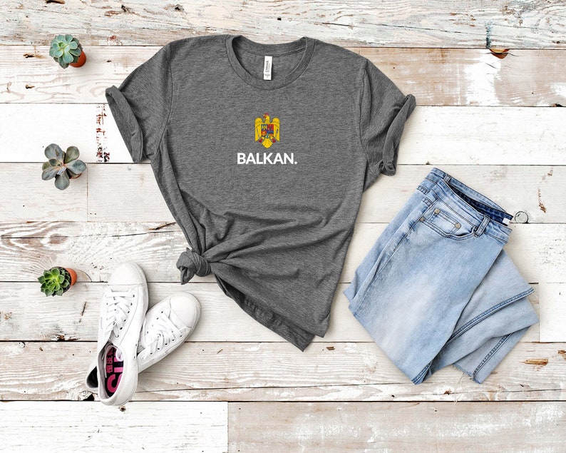 May include: A gray t-shirt with a white print of a coat of arms and the word "BALKAN."