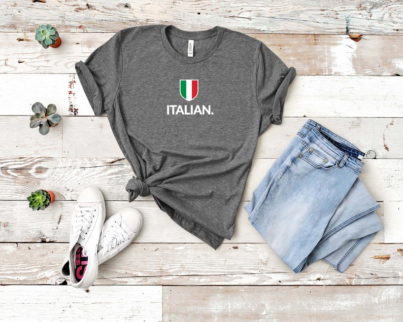 May include: A grey t-shirt with a white Italian flag design and the word "ITALIAN." printed on the front.