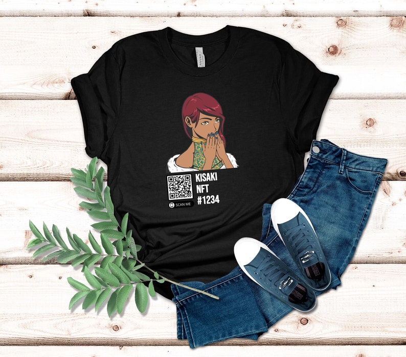 May include: Black t-shirt featuring a graphic of a woman with red hair and a QR code. The text "KISAKI NFT #1234" is below the graphic. The shirt is paired with blue jeans and white sneakers.