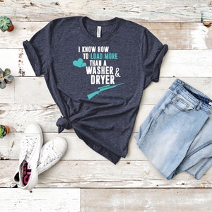 May include: A dark blue t-shirt with the text "I know how to load more than a washer & dryer" in white with a teal rifle and two teal hearts.