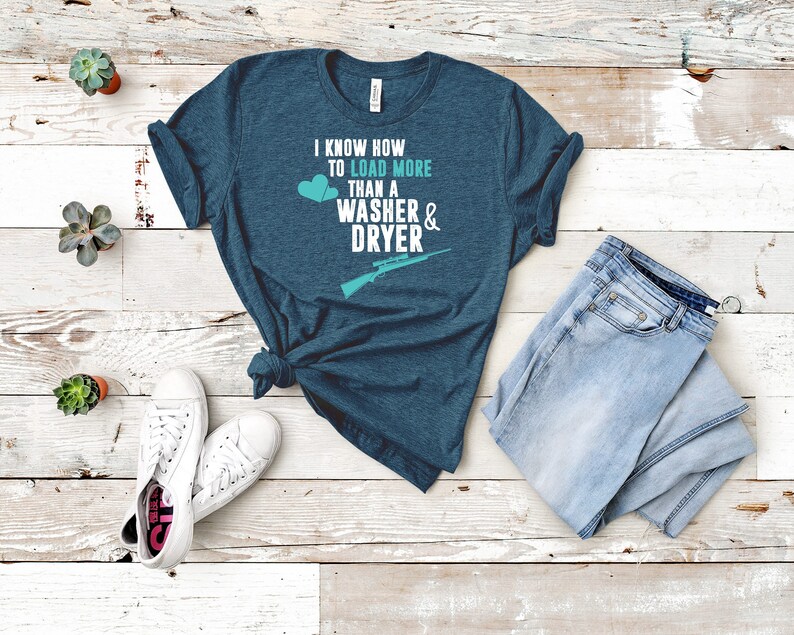 May include: A teal blue t-shirt with the text "I know how to load more than a washer & dryer" and a graphic of a rifle and two hearts.