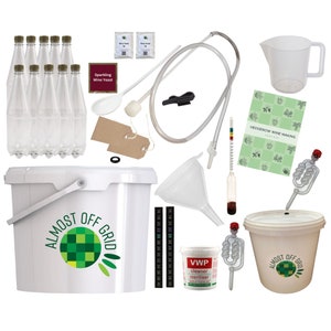 May include: A wine-making kit featuring clear plastic bottles, a white bucket with the text "ALMOST OFF GRID", and a hydrometer. The kit also includes airlocks, a booklet titled "HEDGEROW WINE MAKING", and a container of VWP cleaner steriliser.