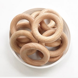 May include: A set of wooden rings, ideal for teething babies. The rings are smooth and natural in colour, and are a great way for babies to explore their senses.