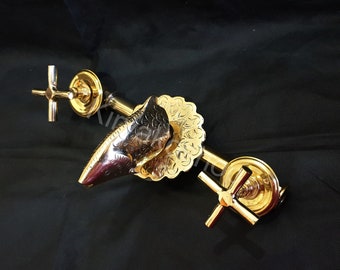 May include: Gold-toned faucet with a decorative spout shaped like a fish head. The faucet has two cross-shaped handles and a round base.