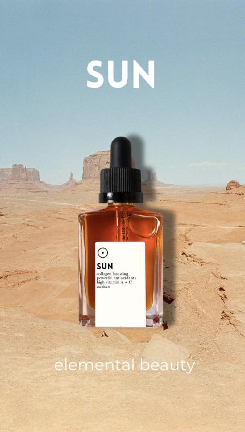 May include: A square amber-colored bottle with a black dropper top, labeled "SUN" in white, sits against a desert landscape. The label also lists "collagen boosting" and "powerful antioxidants." The words "elemental beauty" are at the bottom.