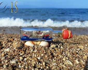 The ship in a bottle. Model of the Greek galley. An elite gift for holidays. Handmade souvenir.