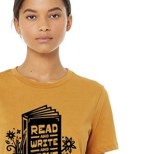 May include: A mustard yellow t-shirt with a black graphic of a book with the text "Read and Write and Fight".