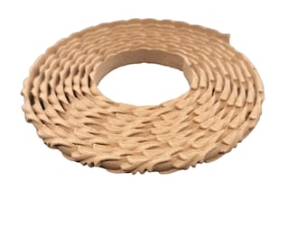May include: A close-up of a brown, textured, corrugated cardboard trim. The trim is rolled up in a circle.