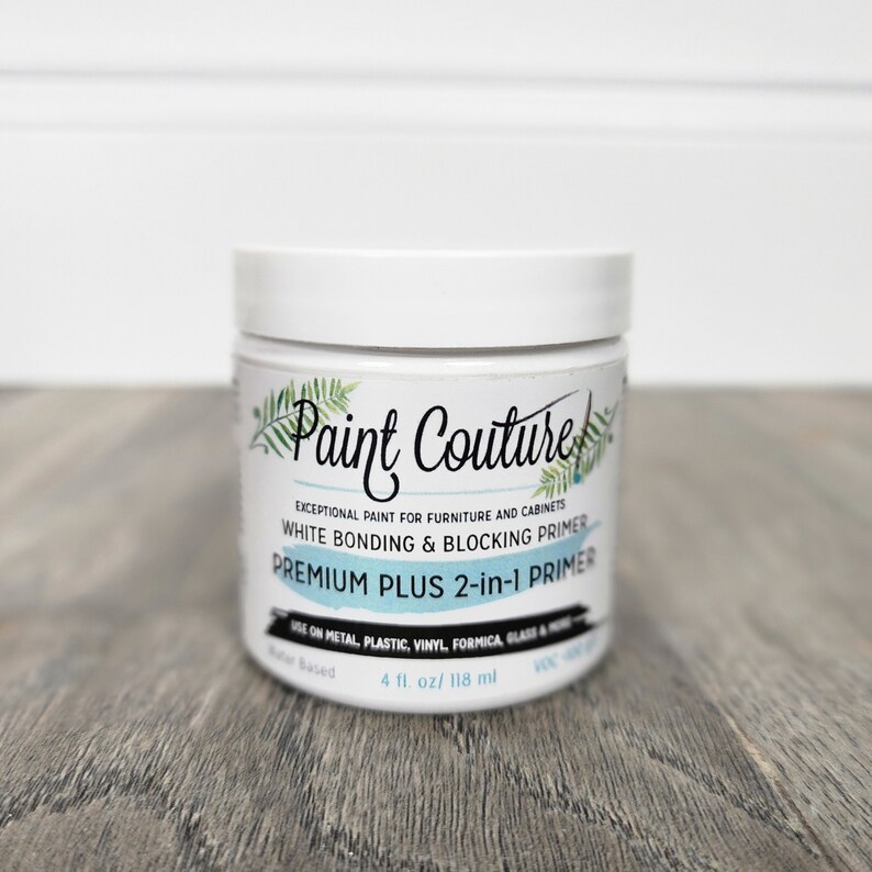 May include: A white jar of Paint Couture Premium Plus 2-in-1 Primer. The jar is labelled "Exceptional paint for furniture and cabinets. White bonding & blocking primer. Premium Plus 2-in-1 Primer. Use on metal, plastic, vinyl, formica, glass & more. Water based. 4 fl. oz/ 118 ml."